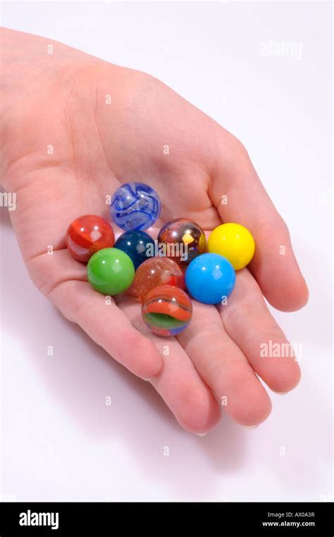 Marbles In A Childs Hand Stock Photo Alamy