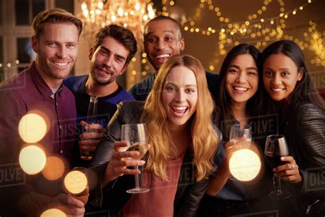 Portrait Of Friends With Drinks Enjoying House Party Stock Photo
