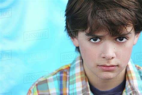 Portrait Of Boy With Brown Hair And Brown Eyes Wearing A Plaid Shirt