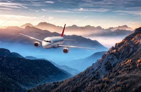 Airplane Is Flying Over Mountains Stock Photo Containing Airplane And