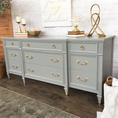 To start the replacement process, gather a screwdriver, a drill, new hardware, wood filler. grey painted dresser with gold hardware (With images ...