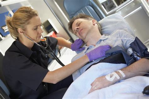 Paramedic Attending To Patient In Ambulance Stock Image Image Of