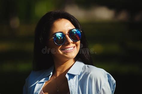 Brunette With Dazzling Smile In Sunglasses Looking At The Sun Stock