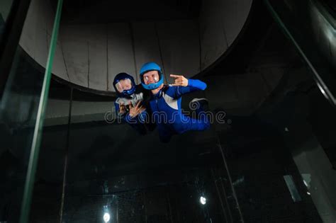 A Man Teaches A Boy To Fly In A Wind Tunnel Lack Of Gravity Stock