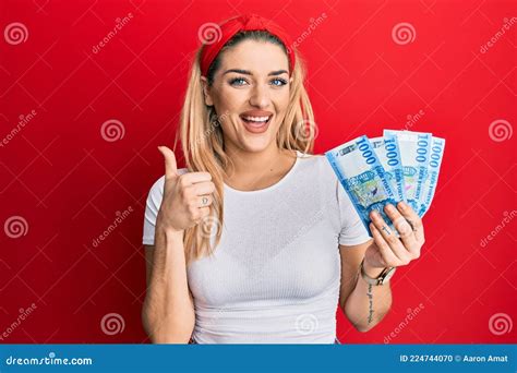Young Caucasian Woman Holding 1000 Hungarian Forint Banknotes Smiling Happy And Positive Thumb