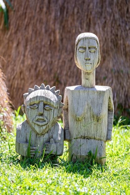 Premium Photo Vintage Wooden Statue Of Man And Woman In Yard On The