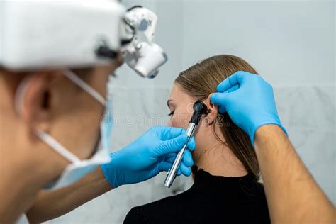 Male Doctor Or Ent Specialist Examining The Ear With An Endoscope With