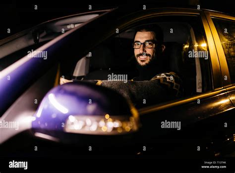 Portrait Of Confident Man Driving Car At Night Stock Photo Alamy