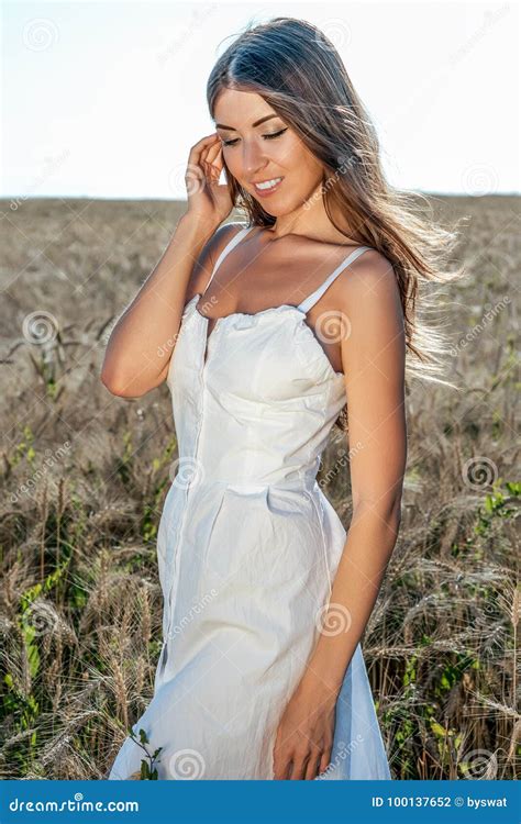 Beautiful Summer Girl In A Wheat Field In A White Dress Tanned Skin