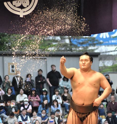 Sumo Champion Hakuho Tosses A Handfull Of Salt To Purify The Ring At An