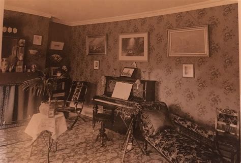 English Middle Class Victorian Parlour Drawing Room Interior With Floral Wallpaper And Curtained