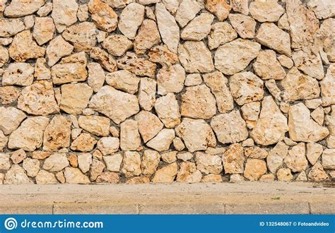 Natural Stone Wall Background Texture Scene With Sidewalk Stock Image