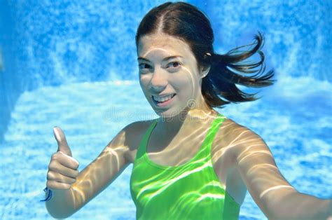 Girl Swims In Swimming Pool Underwater Happy Active Teenager Dives And