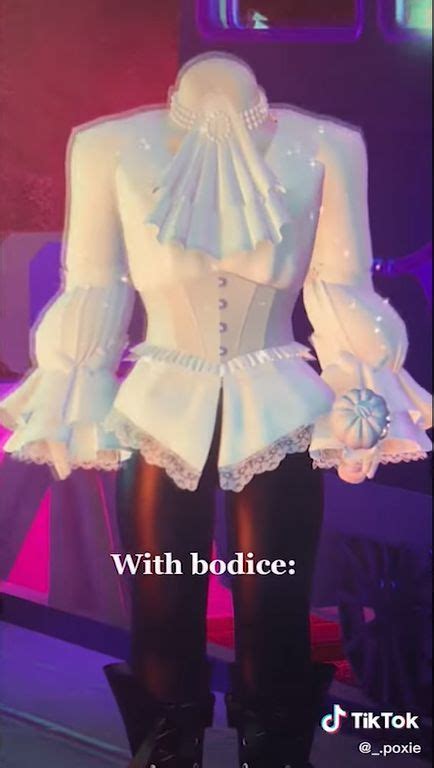 A Mannequin Dressed In White And Black With Lace On The Bottom