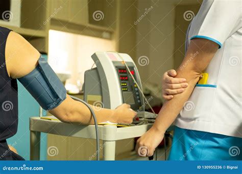 Nurse Checking Blood Pressure On Monitor Screen For Patient Health In