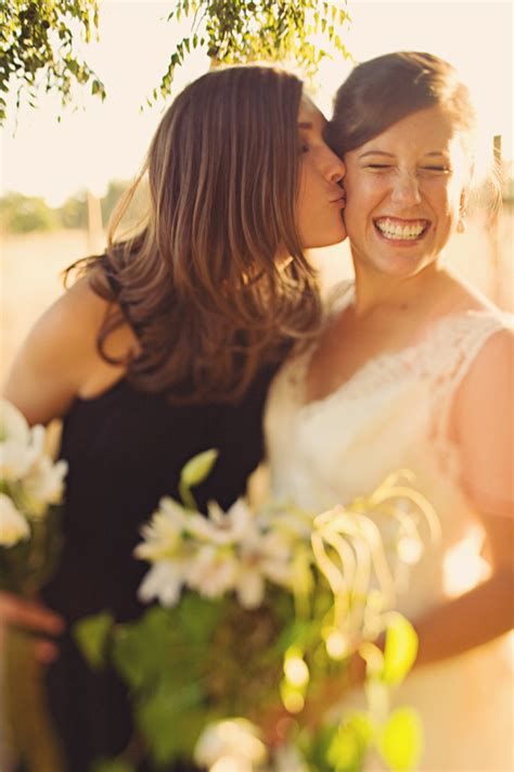 Beautiful Bride Laughing As Bridesmaid Kisses Her On The Cheek Photo By Seattle Based Wedding