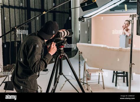 Cameraman Filming Beautiful Woman In Photo Studio Stock Photo Alamy