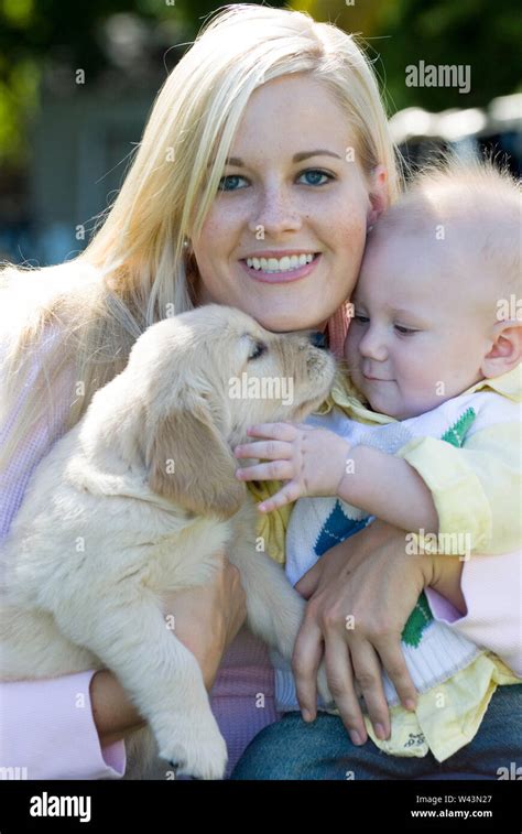 Portrait Of A Mother Baby And Golden Retriever Puppy Stock Photo Alamy
