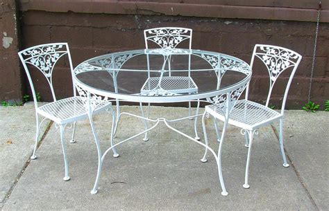 A total of five pieces. Dining Table: Fascinating Round White Wrought Iron Outdoor ...