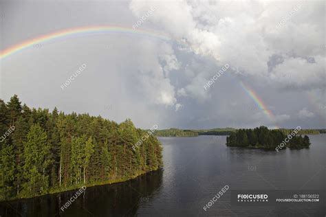 Rainbow Over Green Forests On Islands In Lake — Sun Lighted Tranquil