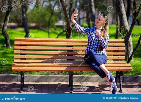Young Woman Rest On Park Bench And Take Selfie Stock Image Image Of Cell Call 124857111