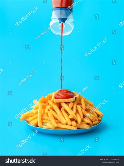 Pouring Ketchup Bottle Over French Fries Stock Photo 2232323717