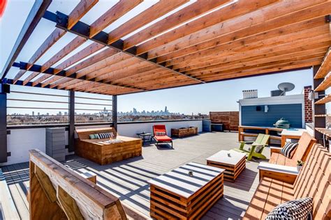 modern rooftop deck in logan square chicago with wooden pergola wooden patio furniture a teal