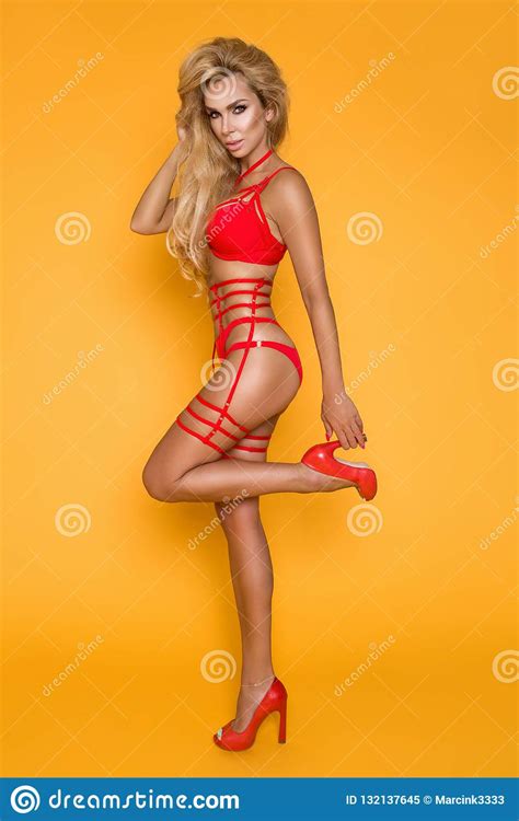 Blonde Model In Red Lingerie On A Yellow Background Stock Image Image Of Attractive Doll