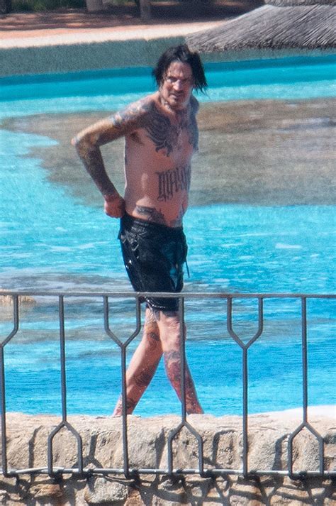 tommy lee goes for a shirtless swim after breaking ribs and quitting motley crue tour barrel of