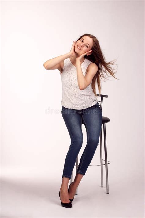 Single Happy Young Woman Sitting On A White Chair Stock Photo Image