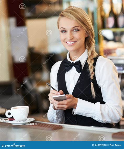 Service With A Smile Portrait Of An Attractive Waitress Taking Coffee Orders For The Morning