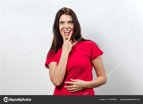 Young Beautiful Girl Showing A Gesture Tongue Between Two Fingers