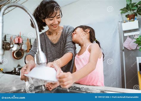 Little Girl Help Her Mother In Washing Dishes Stock Photo Image Of