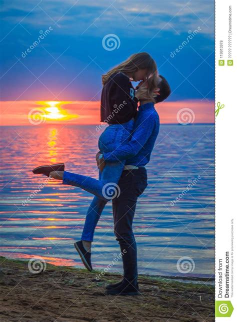 Couple In Love At Sunset By The Sea Stock Photo Image Of People