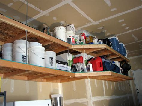 The wooden overhead garage storage shelves are designed to fit into that unused space above the garage doors (you need 16 in. DIY hanging wood shelves. | Ceiling Overhead Storage Ideas ...
