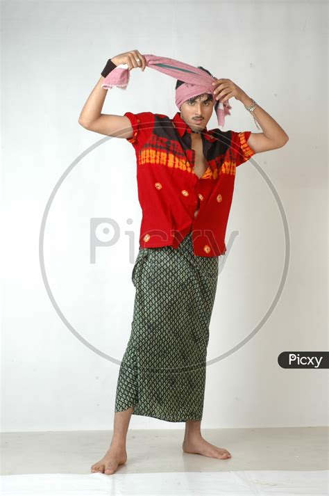Image Of An Indian Man In Traditional Rural Man Attire Wearing Lungi And Gamcha Or Towel On Head