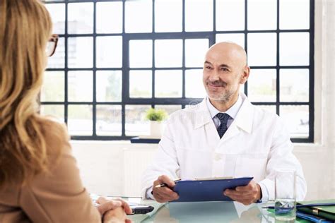Male Doctor Consulting With His Female Patient In Doctor S Office Stock Image Image Of Female