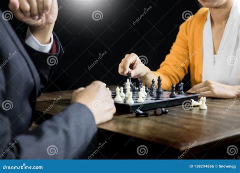 Hand Of Businessman Moving Chess Figure In Competition Board Game For