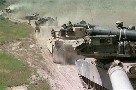 A Convoy Of M1a1 Abrams Tanks Advances Up A Dirt Road At Camp Pendleton