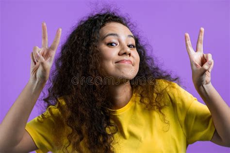 Pretty Woman With Curly Hair Showing With Hands And Two Fingers Air