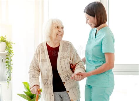 Caregiver Helping Elderly Woman To Walk Stock Photo Image Of Elderly