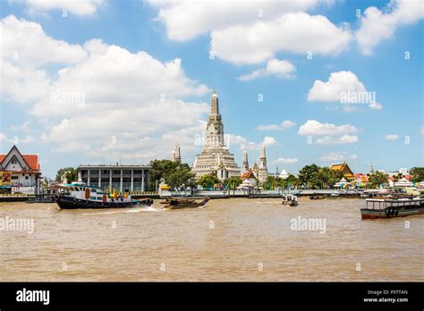 A Tug Boat Trundles Past The Temple Of Dawn Wat Arun On The Chao