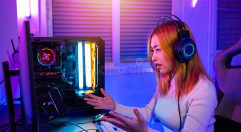 Angry Asian Gamer Wearing Gaming Headphones Playing Joystick Console
