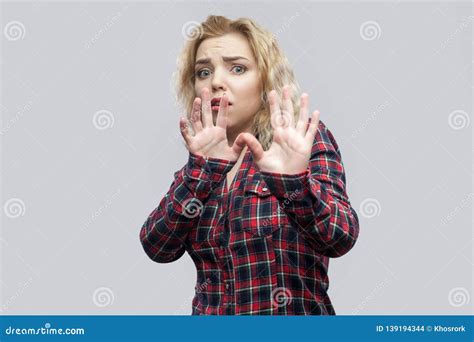 Portrait Of Scared Beautiful Blonde Young Woman In Casual Red Checkered Shirt Standing With