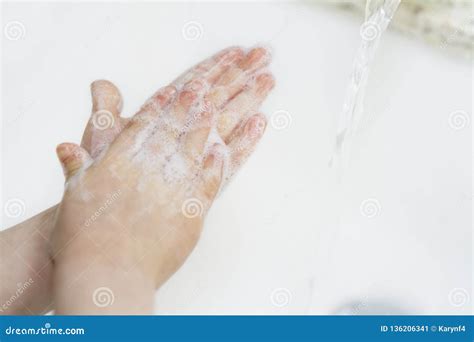 Young Child Washes Hands With A Sparkly Green Bar Of Soap Stock Image