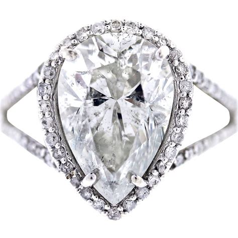 Choose crisscut for maximum size and brilliance. White Gold Pear Shaped Diamond Halo Style Pave Engagement Ring