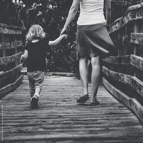 Mother And Daughter Holding Hands By Stephenwmorris Stocksy United