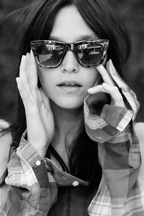 A Portrait Of A Woman Holding Sunglasses To Her Face Stocksy United Eyewear Photography