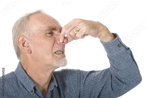 Old Man Pinching His Nose At Bad Smell Stock Photo And Royalty Free