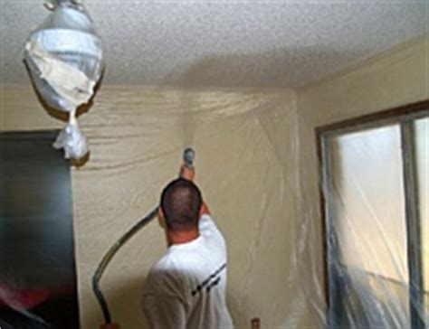 Using an airless paint sprayer to paint a begin at an edge where the ceiling and wall meet. Apply, Repair, Paint, Remove Popcorn Ceiling (South NJ)